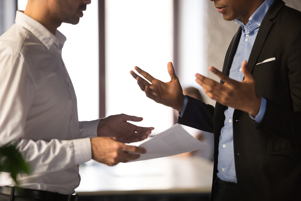 Stock image of a manager speaking to an employee.