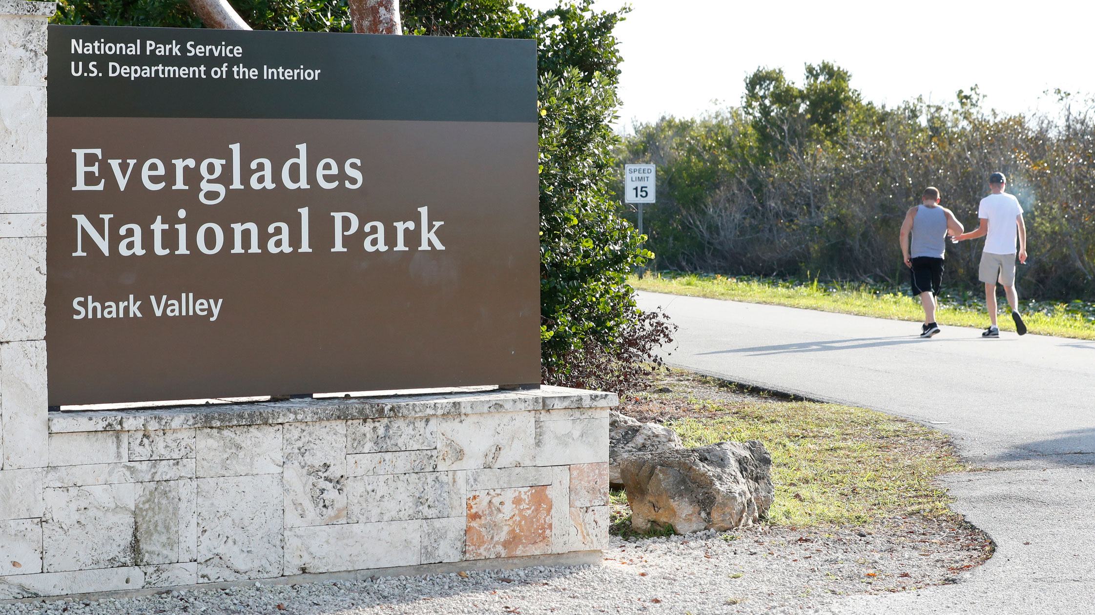 FILE - Visitors walk past a sign for Everglades National Park as they enter from overflow parking, Wednesday, Jan. 2, 2019, in Everglades National Park, Fla. Officials say a man visiting the Florida Everglades is recovering after being bitten by a crocodile after falling off a boat. The National Park Service says the attack occurred Sunday, March 10, 2024, at the Flamingo Marina in Everglades National Park.