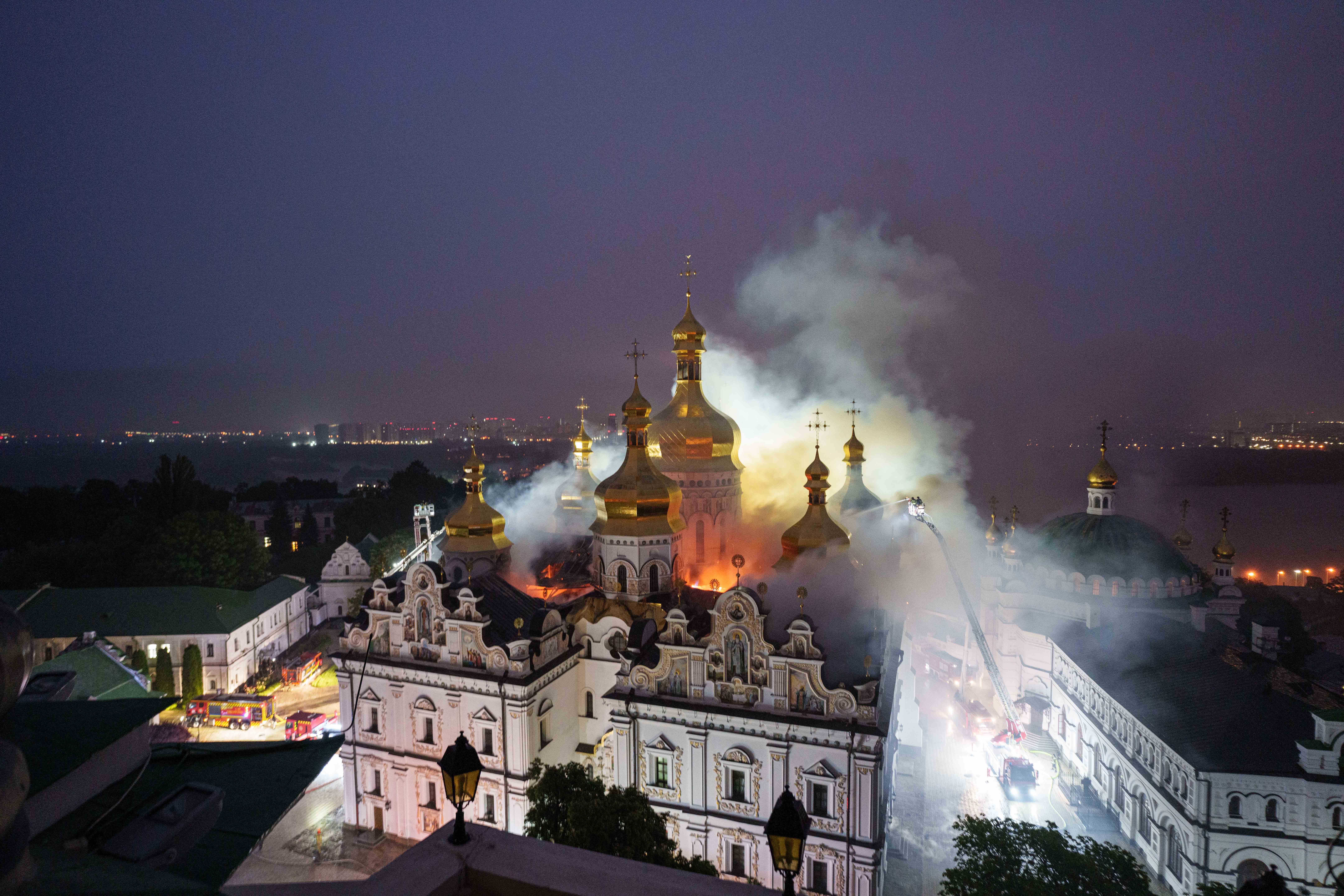 Rescue workers try to put out a fire at the Dormition Cathedral of thousand-year-old Monastery of Caves, also known as Kyiv Pechersk Lavra, following a Russian strike on Kyiv, Ukraine, Monday, June 15, 2026.