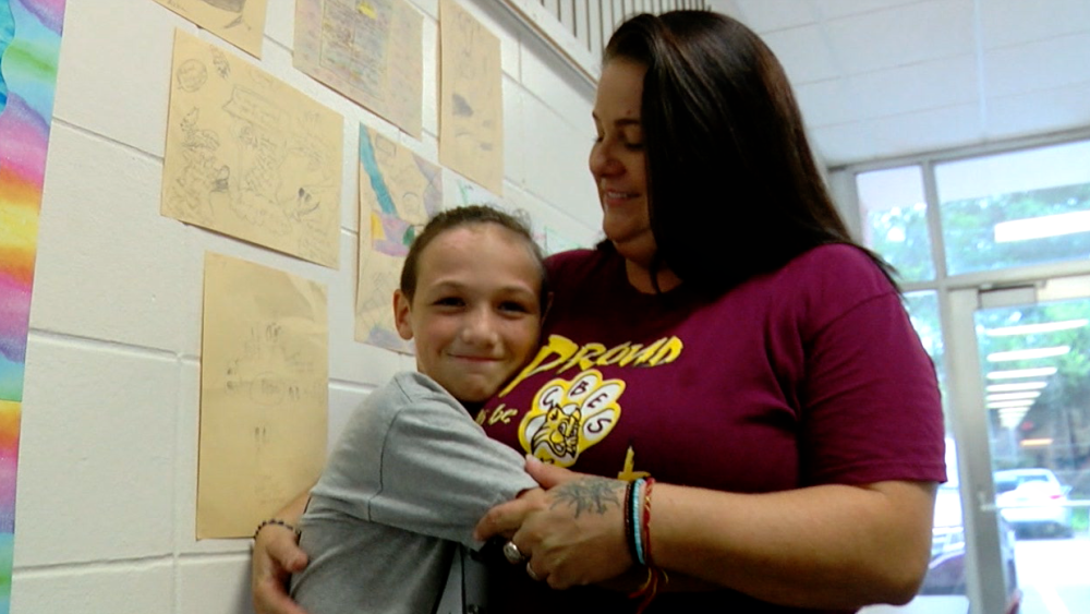Nicole Martone hugs student