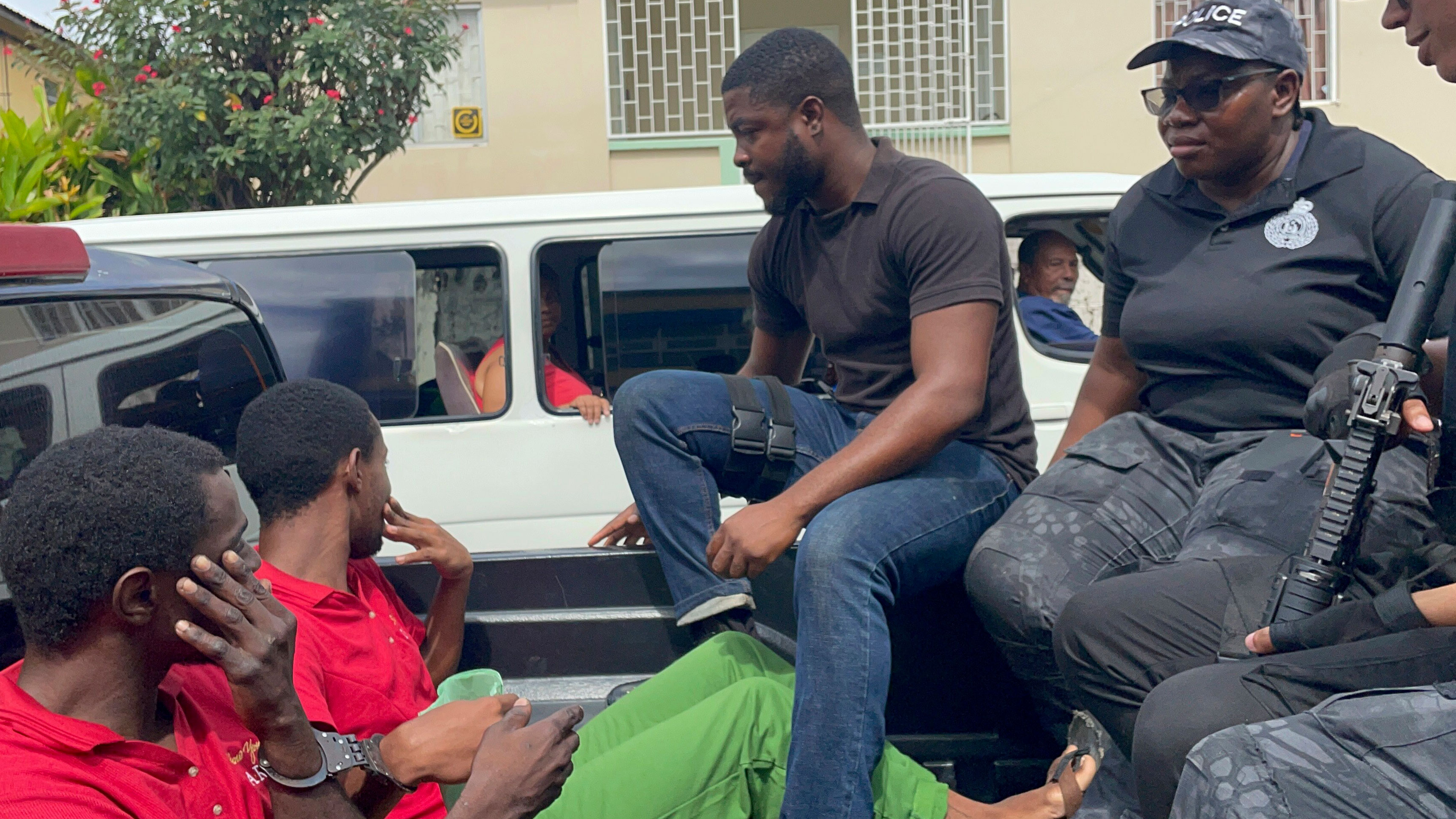 Police transport escaped prisoners Atiba Stanislaus, far left, and Trevon Robertson who are handcuffed together in Kingstown, St. Vincent and the Grenadines, Monday, March 4, 2024. The men had escaped from a police holding cell in Grenada on Feb. 18 and are suspected of hijacking a catamaran while Ralph Hendry and Kathy Brandel, who disappeared, were aboard.