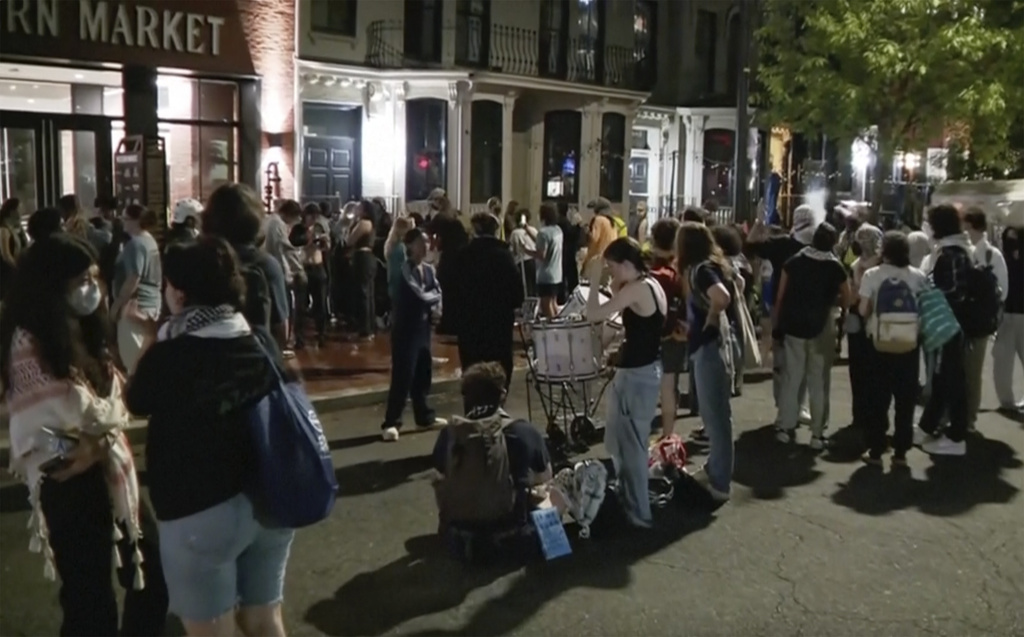 People protesting the Israel-Hamas war stand outside near the campus of George Washington University, in Washington, D.C., Wednesday, May 8, 2024. 