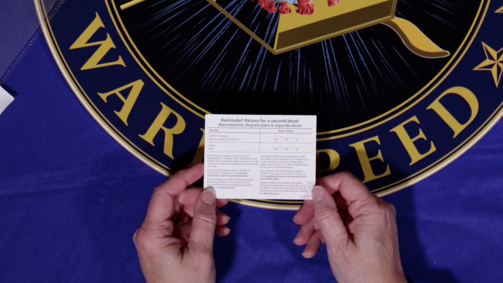 Officials hope these cards remind patients to come back for their second dose of COVID-19 vaccine