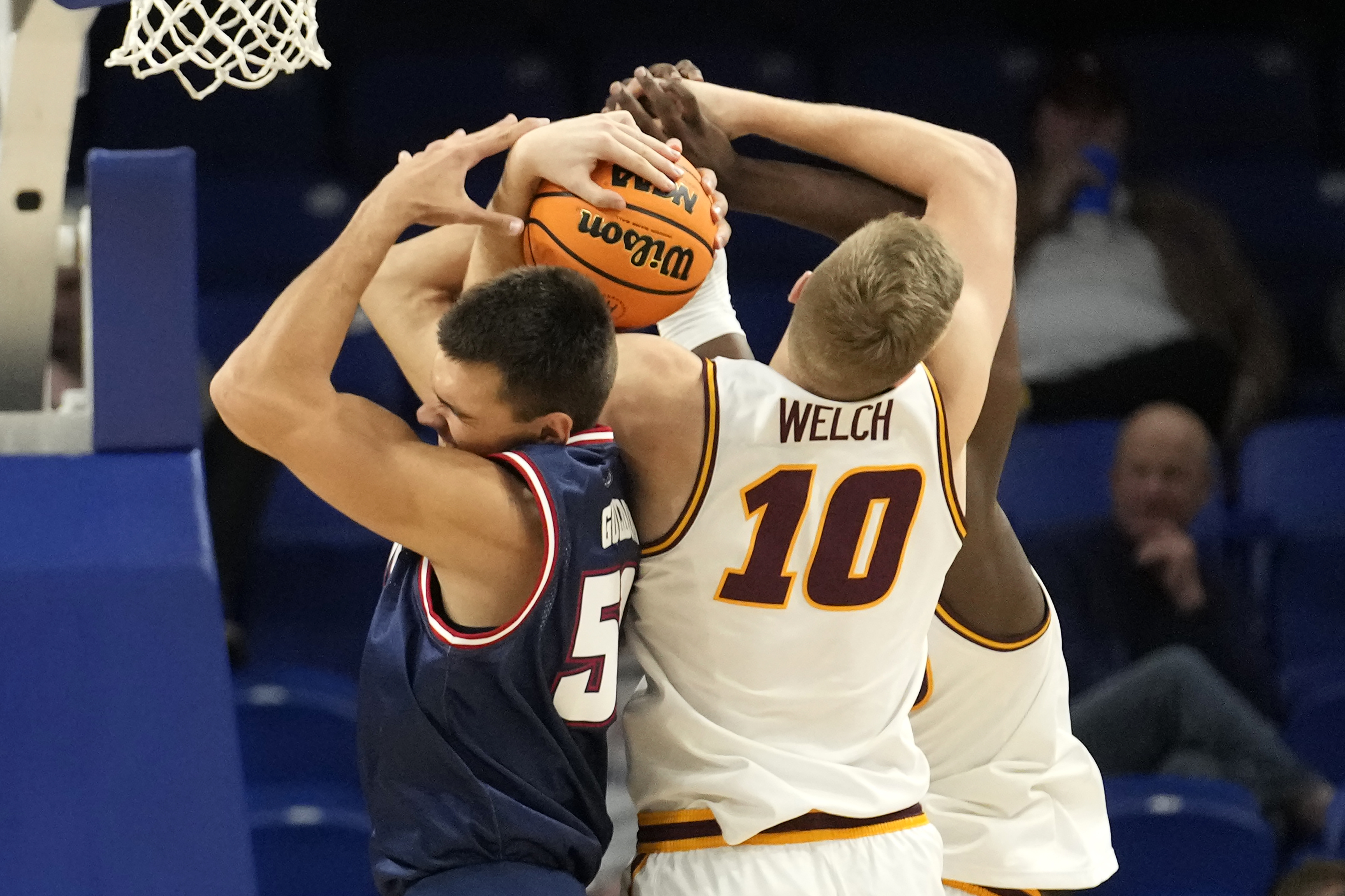 FAU Owls center Vladislav Goldin battles with Loyola Ramblers forward Tom Welch for basketball in first half in Chicago, Nov. 8, 2023
