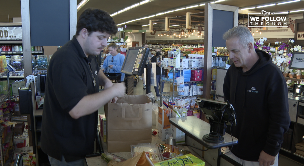 Customers getting paper bags at Barrons Market. 