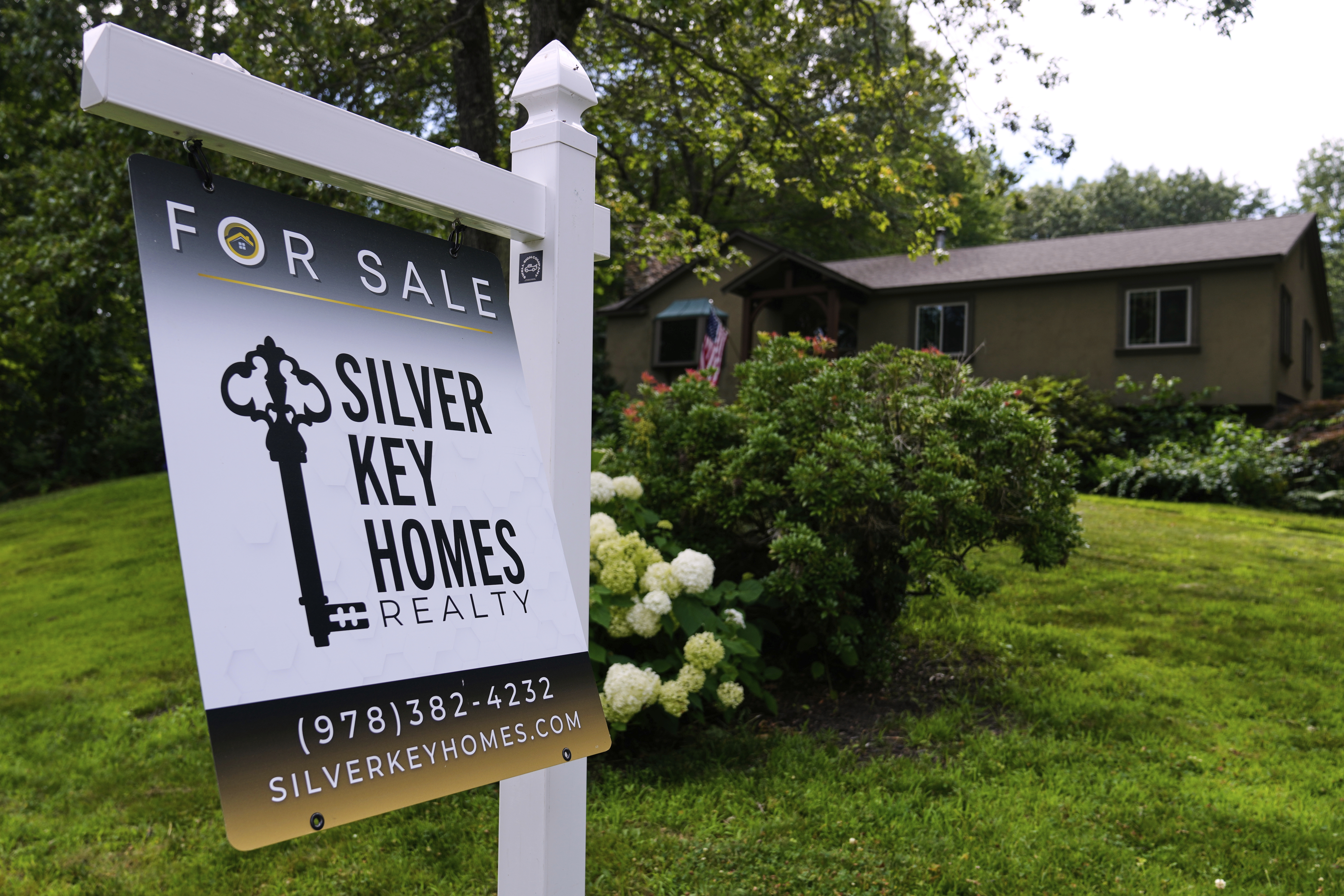 A for sale sign is displayed in front of a single family home, Thursday, July 17, 2025, in Derry, N.H. 