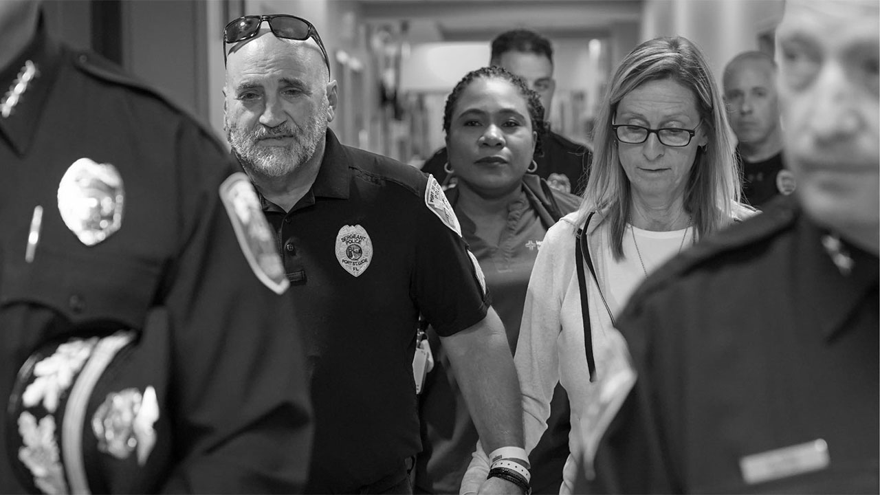 Port St. Lucie police Sgt. Erik Levasseur walks out of HCA Florida Lawnwood Hospital with his wife by his side on Jan. 7, 2026.