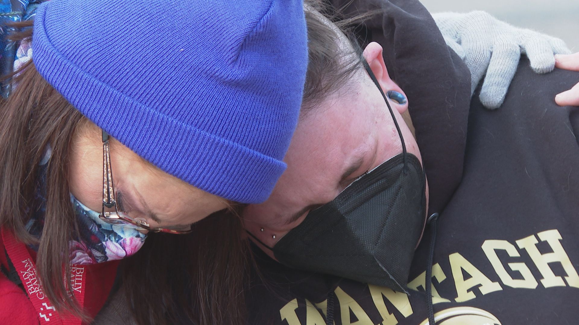 People comfort each other outside the King Soopers in Boulder
