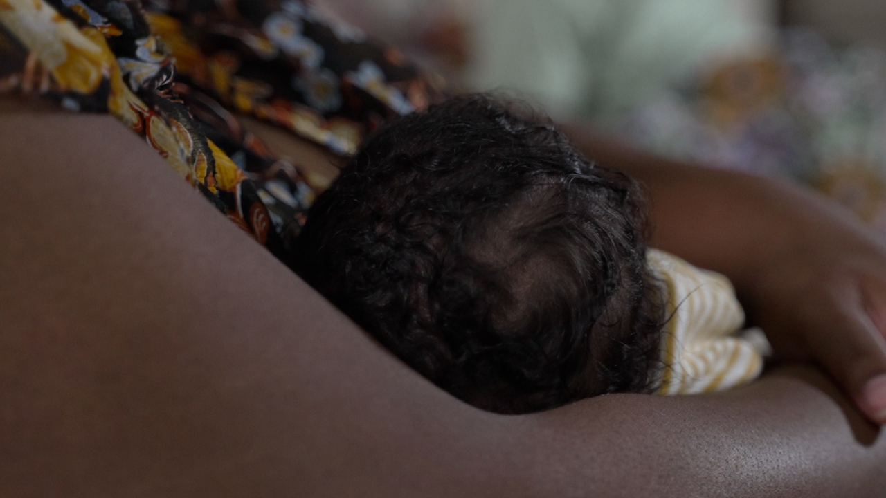 mother holding baby.png