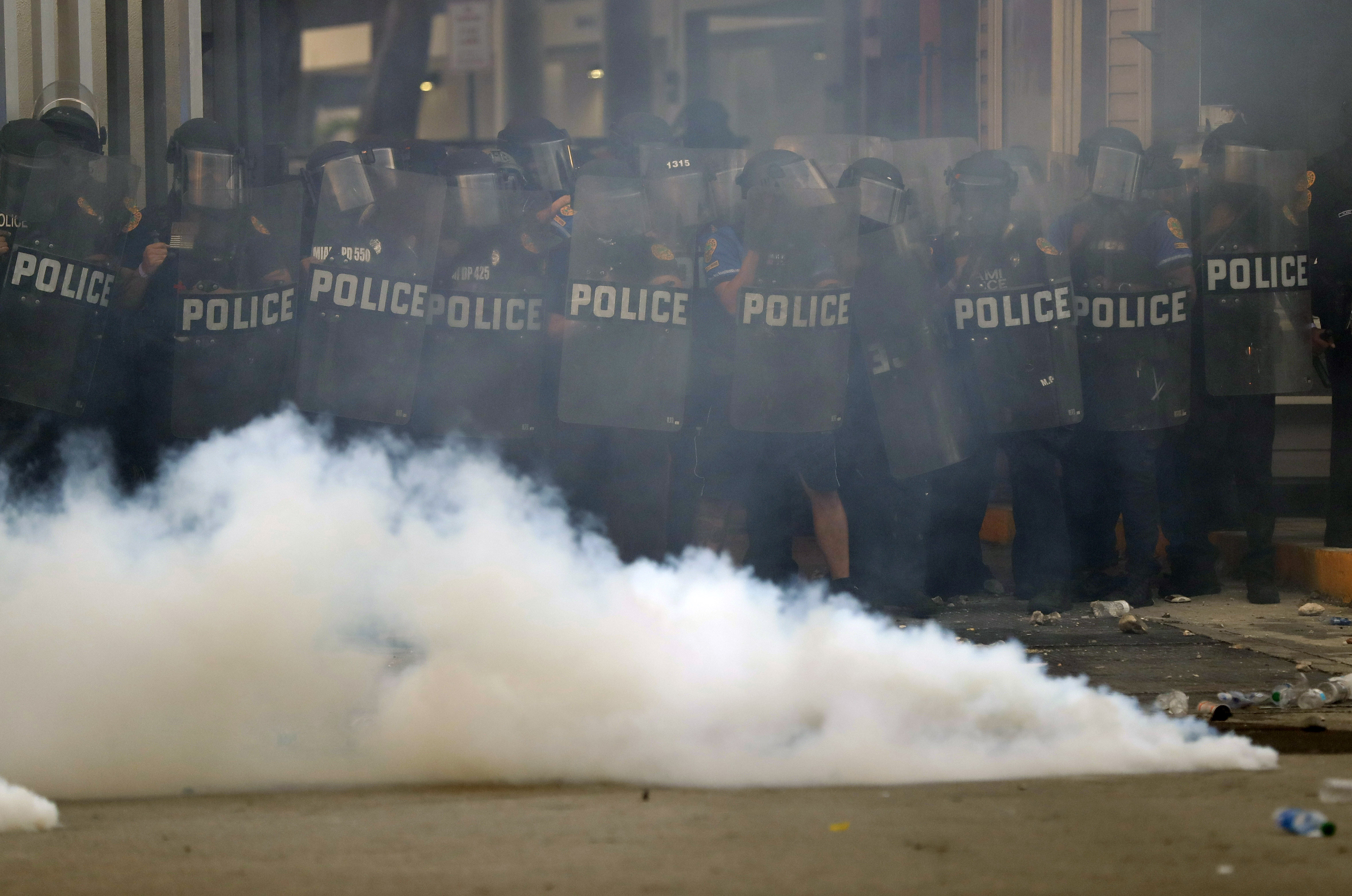 Police hold line as tear gas canister thrown back at them, May 30