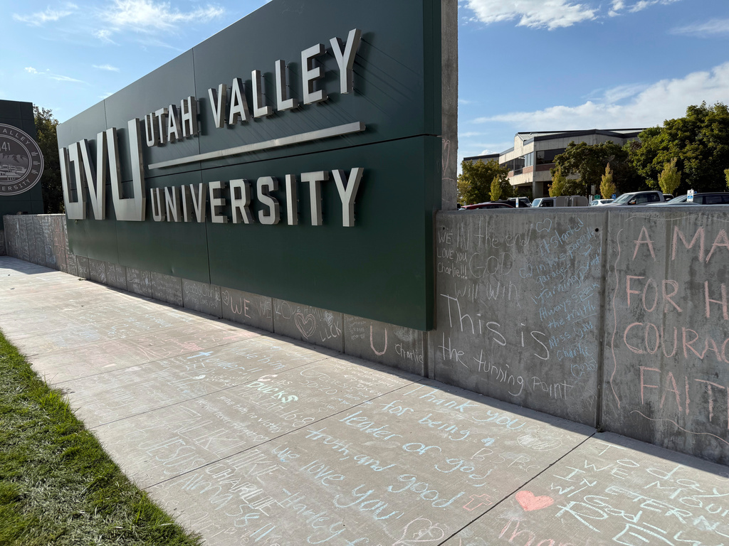 People who brought flowers also wrote messages in chalk at a memorial for Charlie Kirk, who was shot and killed last week, at Utah Valley University, Monday, Sept. 15, 2025, in Orem, Utah.