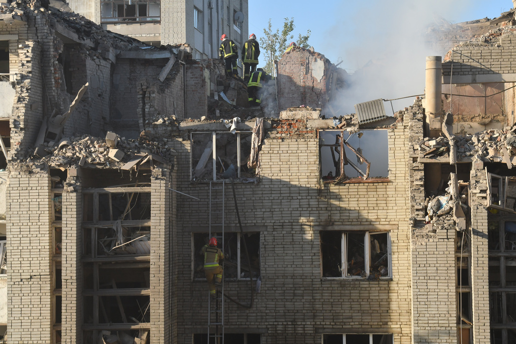 Rescuers search through the rubble of a residential building following air attack in Lviv, Ukraine, Thursday, July 30, 2026. 
