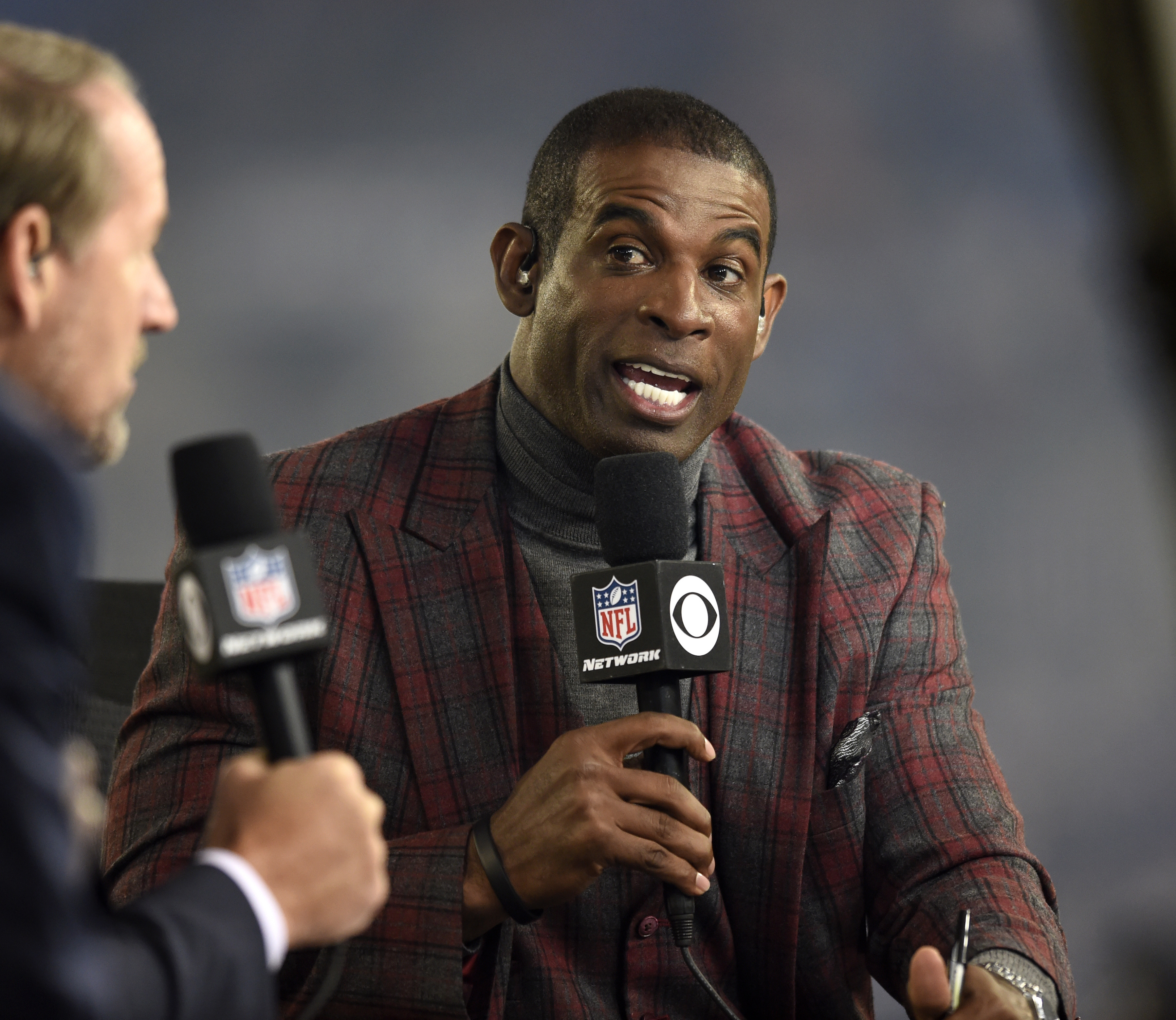 Deion Sanders speaks on the Thursday Night Football set during halftime in an NFL football game between the Baltimore Ravens and the Miami Dolphins,