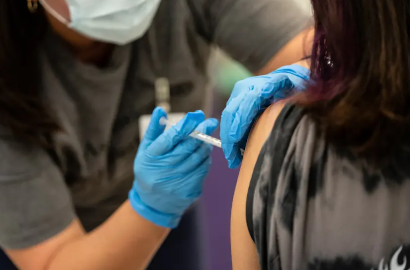 A nurse administers a dose of the Pfizer COVID vaccine at a clinic organized by the Travis County Mobile Vaccine Collaborative at Rodriguez Elementary School on July 28, 2021.