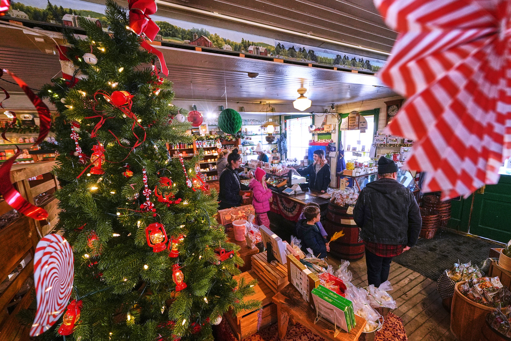 Post-holiday shoppers pass a Christmas tree at Calef's Country Store, Friday, Dec. 26, 2025, in Barrington, N.H. 