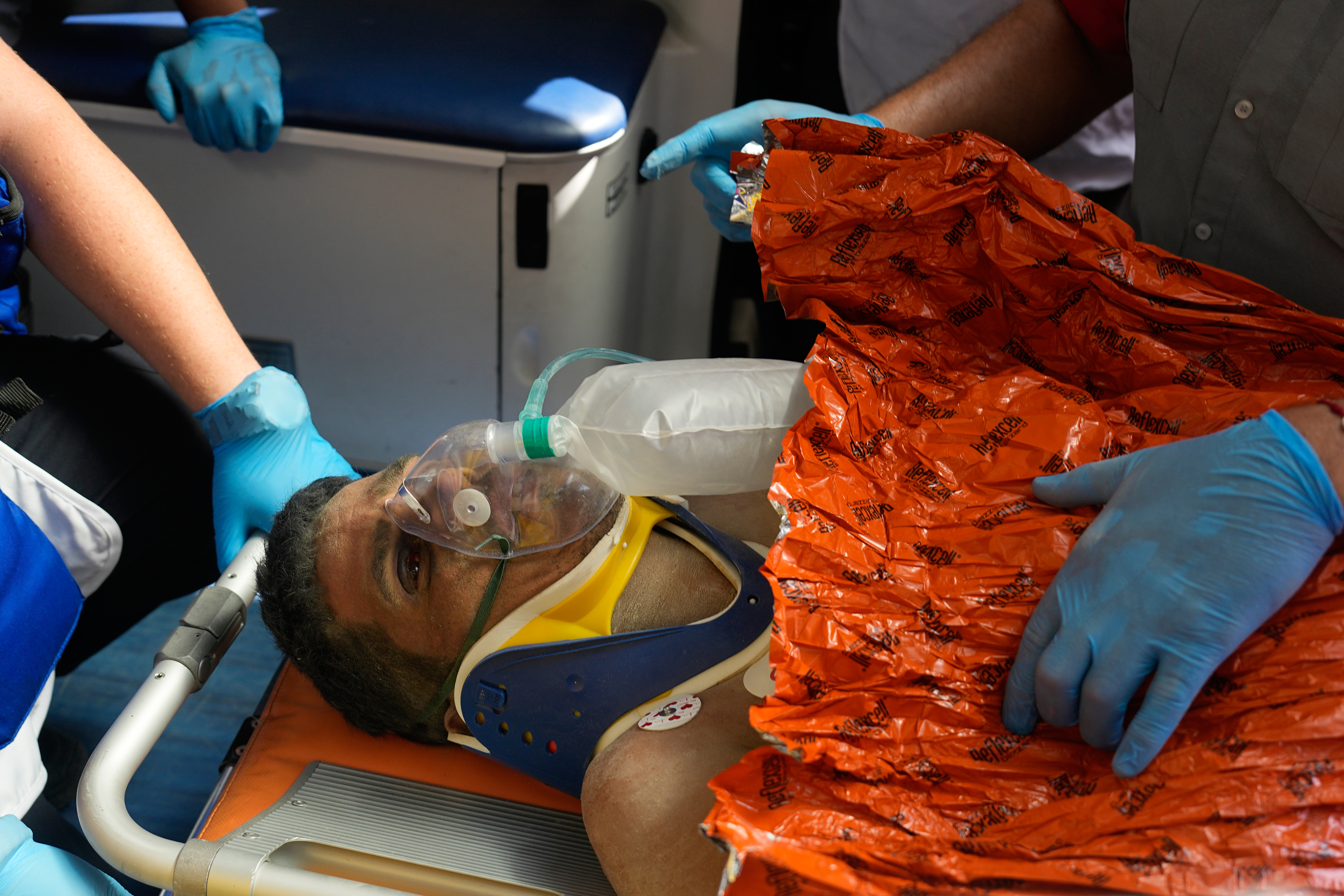 Rescue workers attend to Hernán Alberto Gil Flores after he was pulled from the rubble eight days after he was trapped by twin earthquakes that struck Catia La Mar, Venezuela, Thursday, July 2, 2026.
