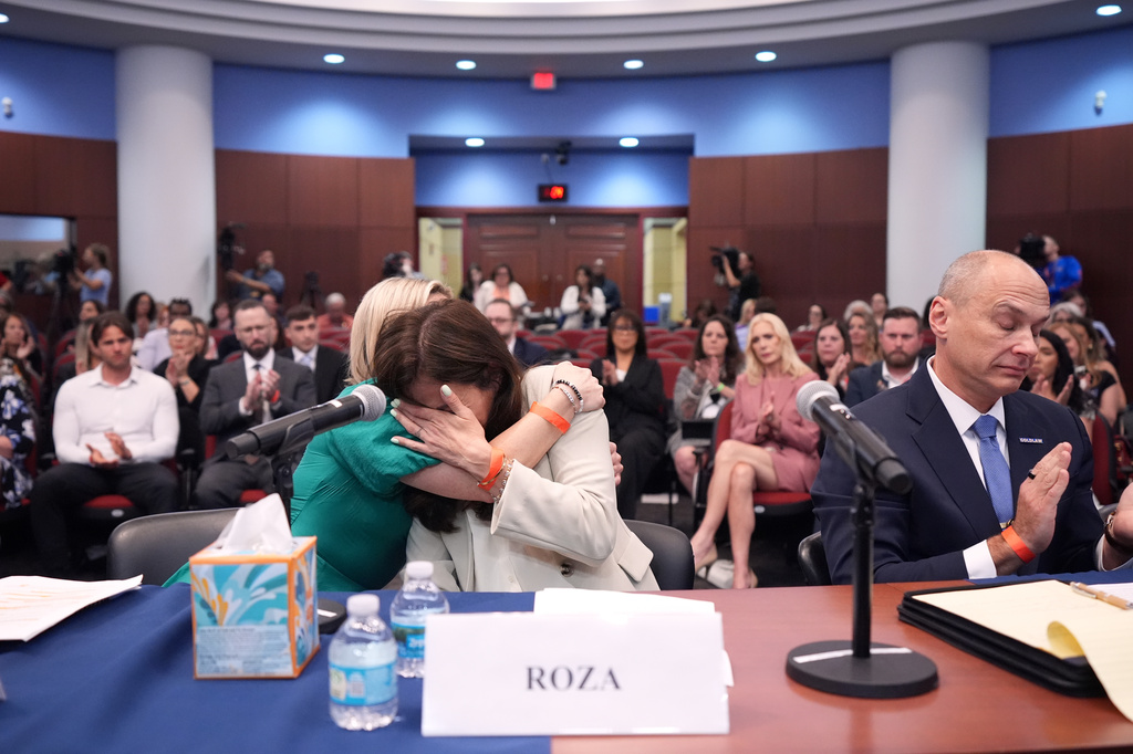Roza, center, a survivor of convicted sex trafficker Jeffrey Epstein's abuses, is comforted by fellow survivor Dani Hannah Bensky, as she is overcome with emotion after addressing House Oversight Committee Democrats at a field hearing focused on the Epstein Investigation, Tuesday, May 12, 2026, in West Palm Beach, Fla.