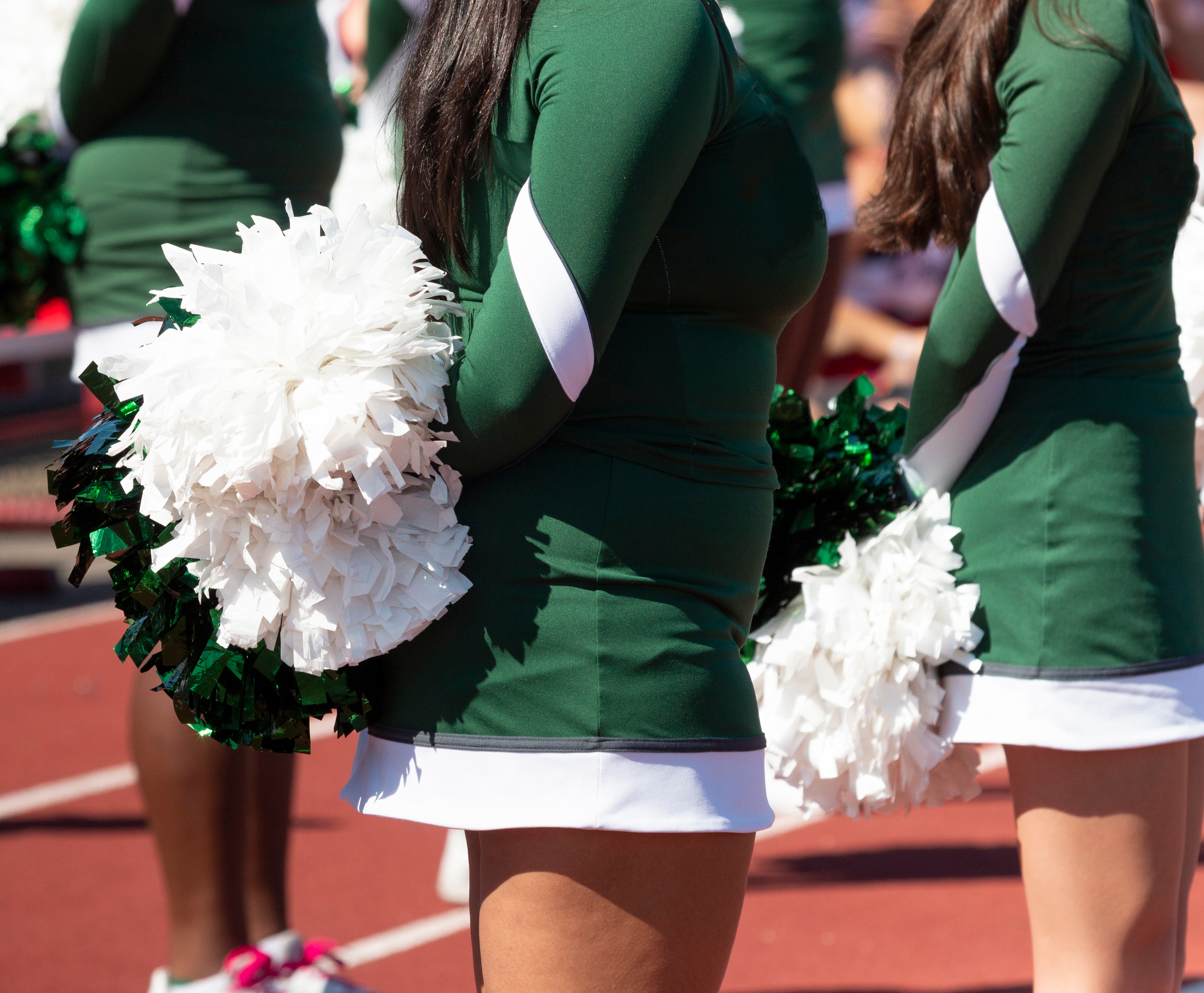  High school cheerleaders on a track. 