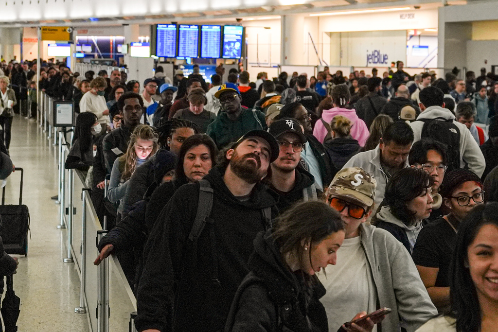 People wait in long TSA security lines at John F. Kennedy International Airport (JFK) in the Queens borough of New York, Monday, March 23, 2026.