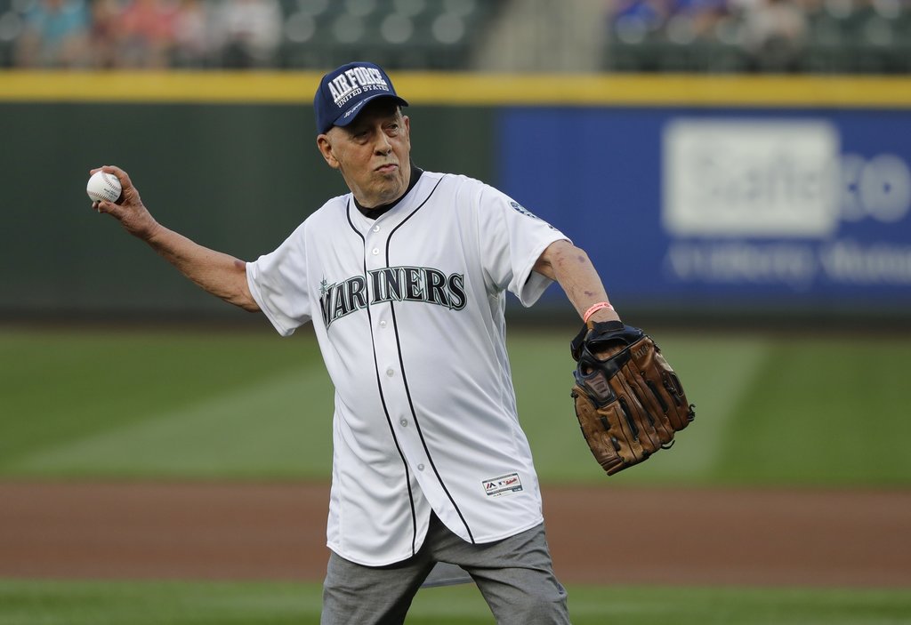 Bill Rasmussen, who founded the TV sports network ESPN along with his son, Scott Rasmussen, throws out the first pitch of a baseball game between the Seattle Mariners and the Toronto Blue Jays, Friday, Aug. 3, 2018, in Seattle. 