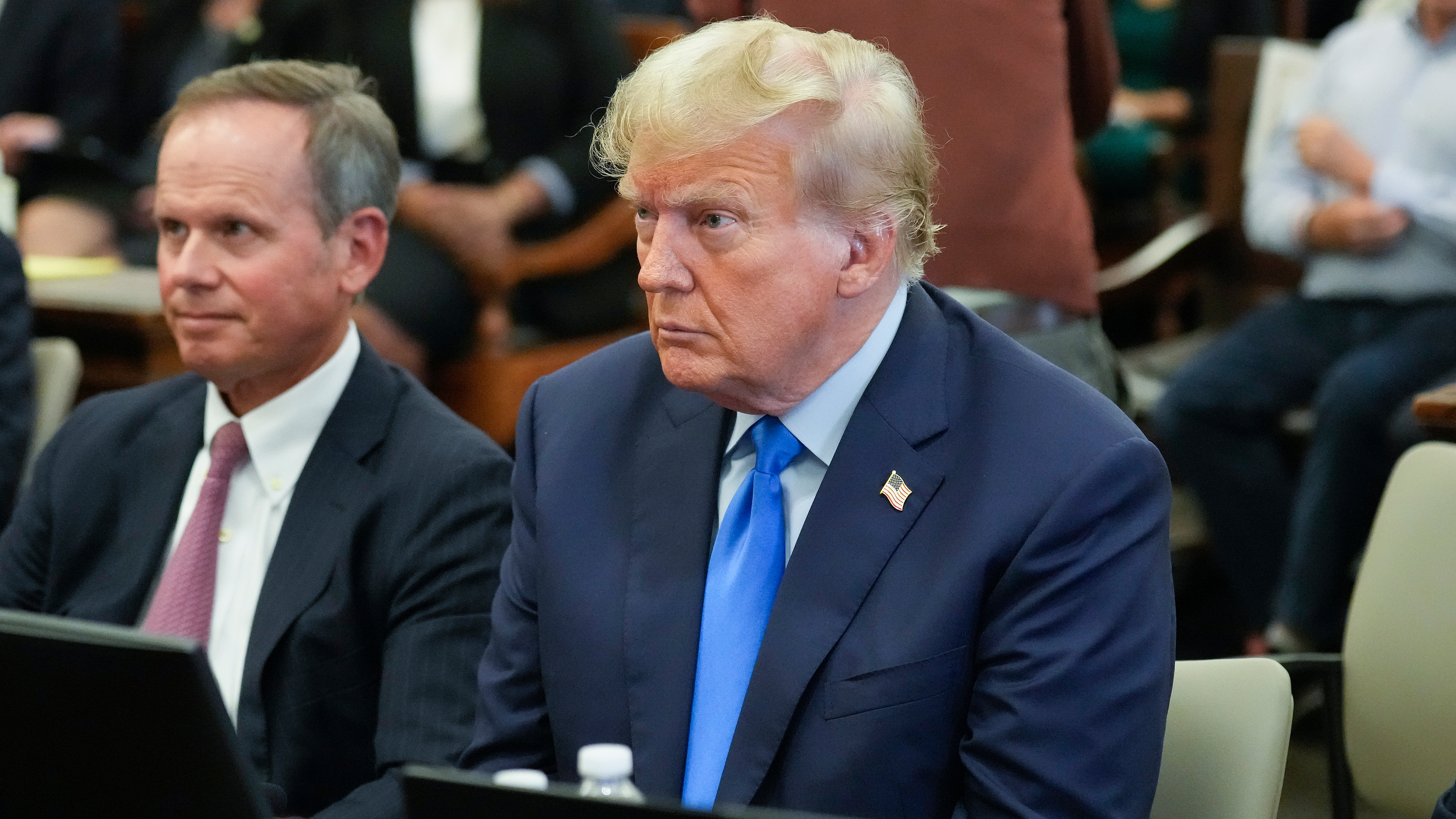 Former President Donald Trump, right, sits in the courtroom at New York Supreme Court, Monday, Oct. 2, 2023, in New York. Trump is making a rare, voluntary trip to court in New York for the start of a civil trial in a lawsuit that already has resulted in a judge ruling that he committed fraud in his business dealings.