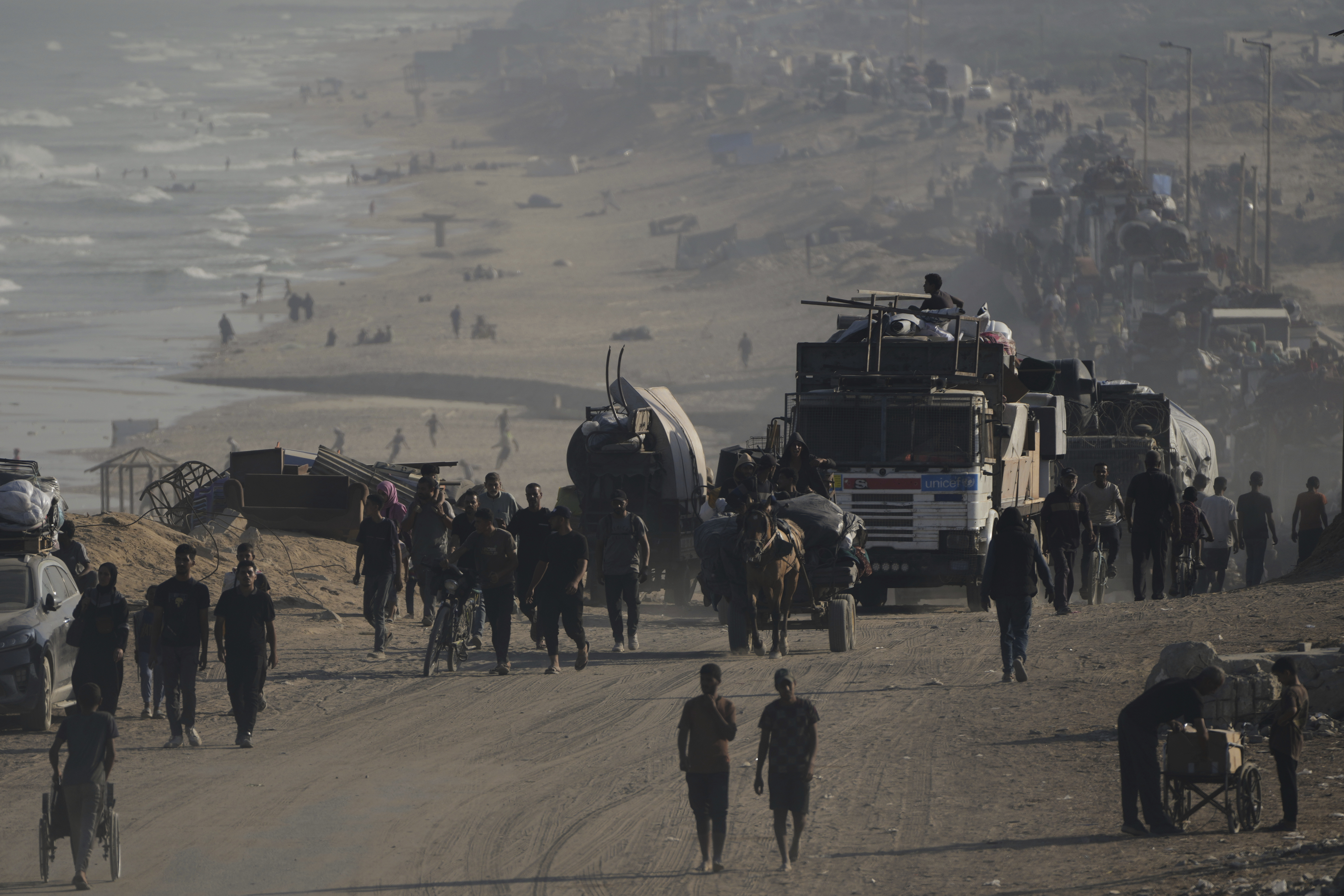 Displaced Palestinians flee Gaza City by foot and vehicles, carrying their belongings along the coastal road toward southern Gaza, Wednesday, Sept. 17, 2025. 