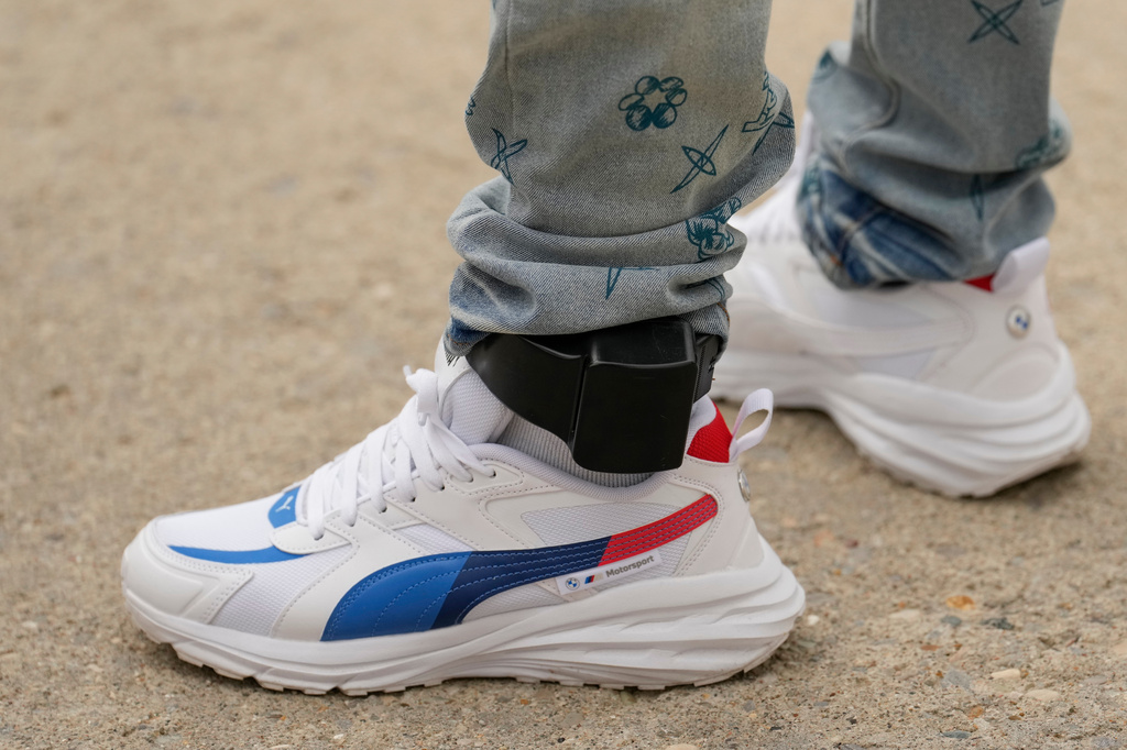 Philbert Viaud, a Haitian resident of Columbus, Ohio, departs the ICE Enforcement and Removal Operations field office with an ankle monitor after an appointment in Cincinnati, Sunday, Aug. 2, 2026.