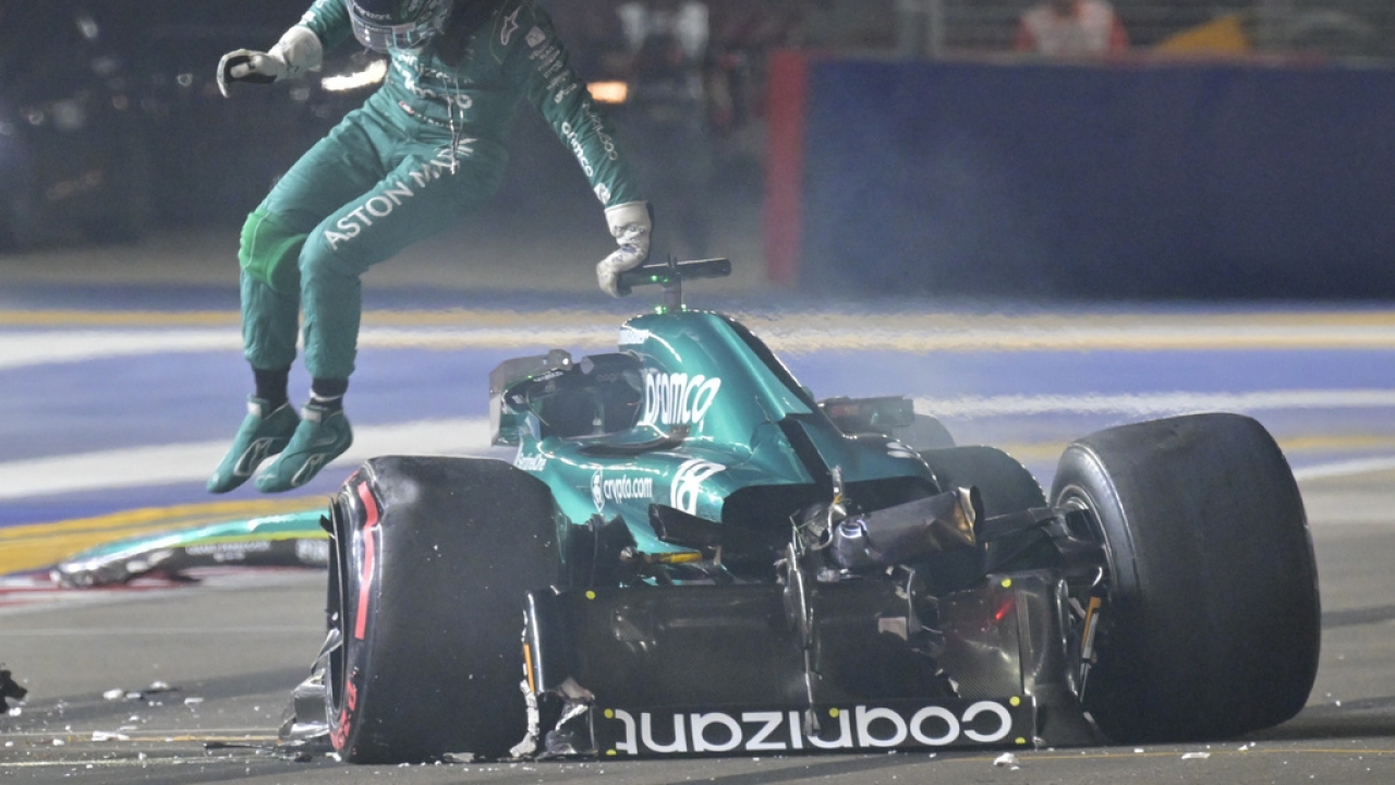 Aston Martin driver Lance Stroll of Canada jumps out from his car after a crash