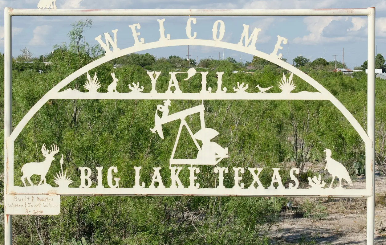 A sign welcoming visitors to Big Lake on Sept. 24. The town, about 200 miles south of Lubbock, is the county seat of Reagan County, where internet service providers are set to receive money to build infrastructure. 