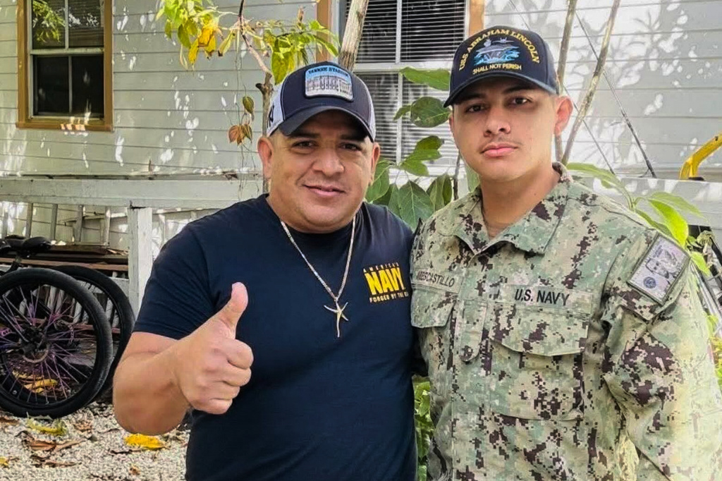 In this photo courtesy of Katherine Delgado shows her step-father Luis Manuel Aviles, left, and her brother Joshua Aviles stand outside their home in Oct. 2025, shortly before Joshua deployed on the USS Lincoln the following month in Key West, Fla.