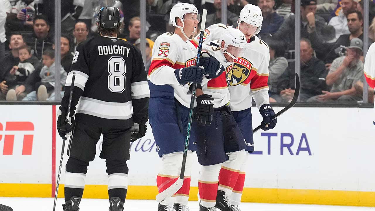 Florida Panthers left wing Brad Marchand, second from right, is helped off the ice by left wing Brady Tkachuk, second from left, and defenseman Niko Mikkola after he was injured as Los Angeles Kings defenseman Drew Doughty looks on during the second period of an NHL hockey game Tuesday, Oct. 6, 2026, in Los Angeles.