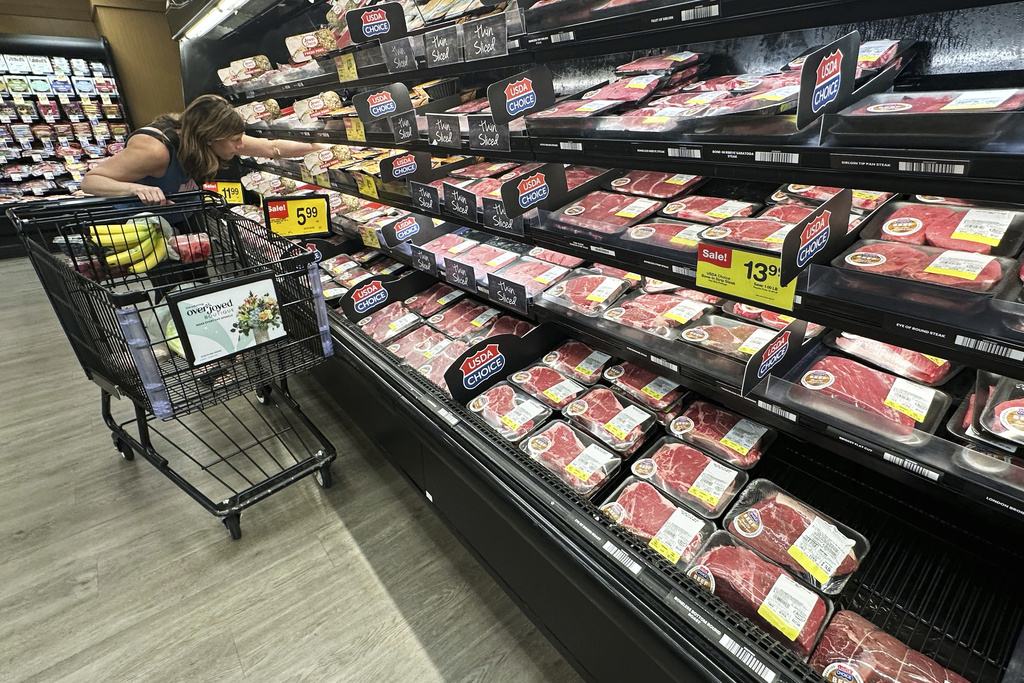 A shopper compares beef prices at a grocery store in Mount Prospect, Ill., Thursday, July 17, 2025.