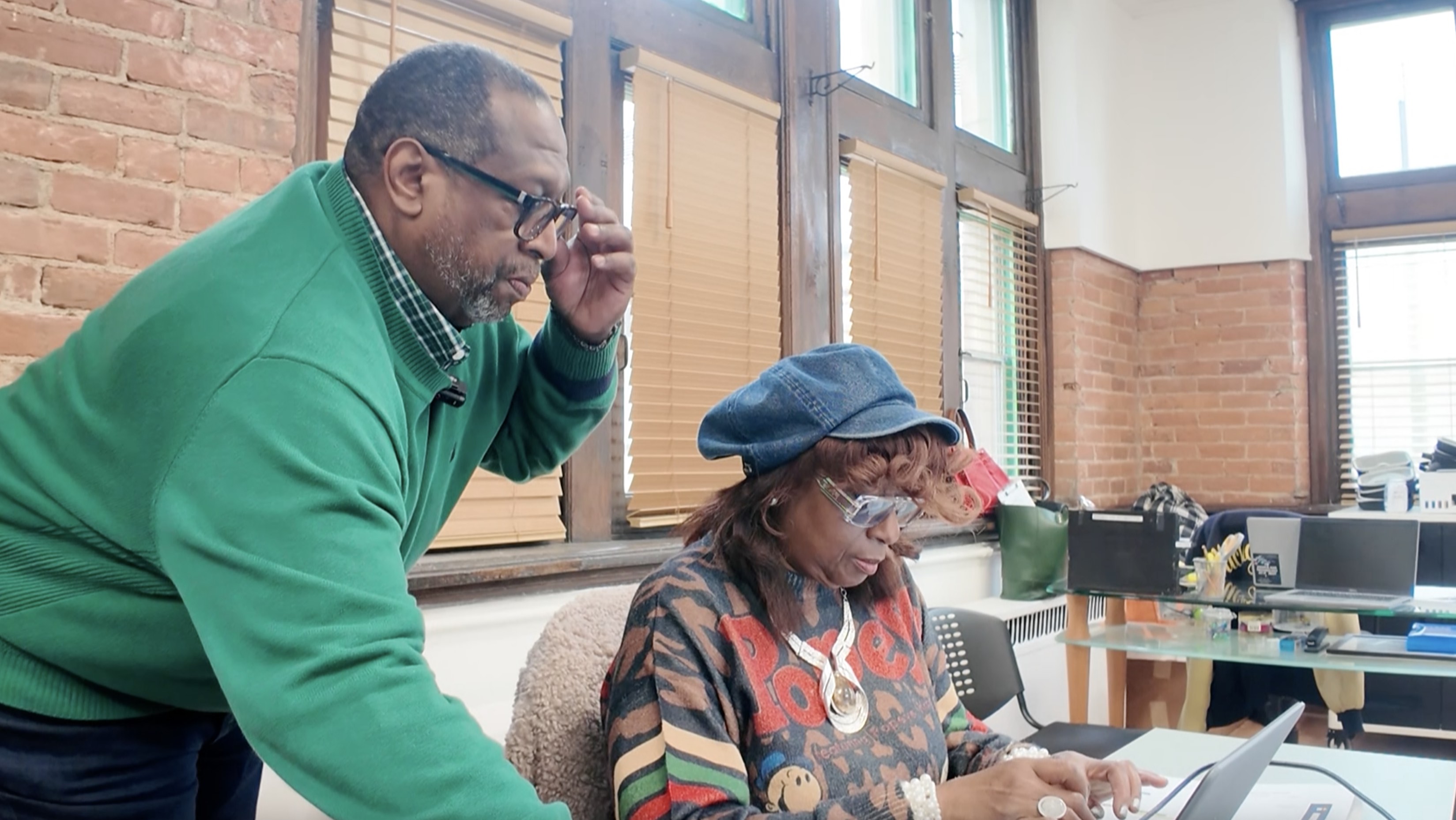 Adult workers using computers at work.