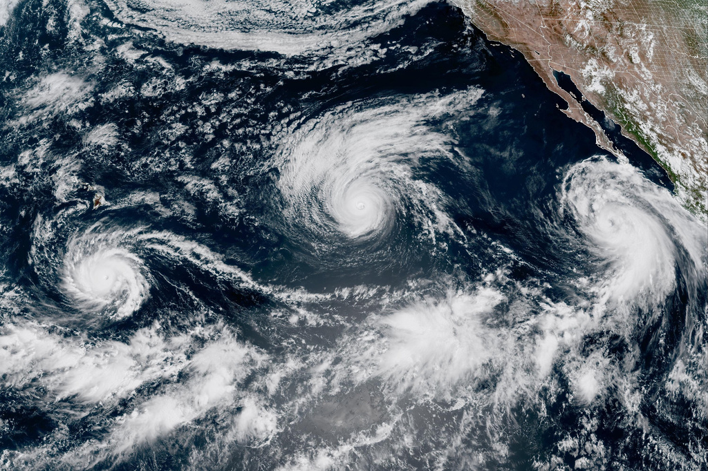 This satellite image provided by CIRA/NOAA shows three storms, from left, Hurricane Lowell, Hurricane Karina and Tropical Storm Marie in the Pacific Ocean on Wednesday, Sept. 2, 2026.