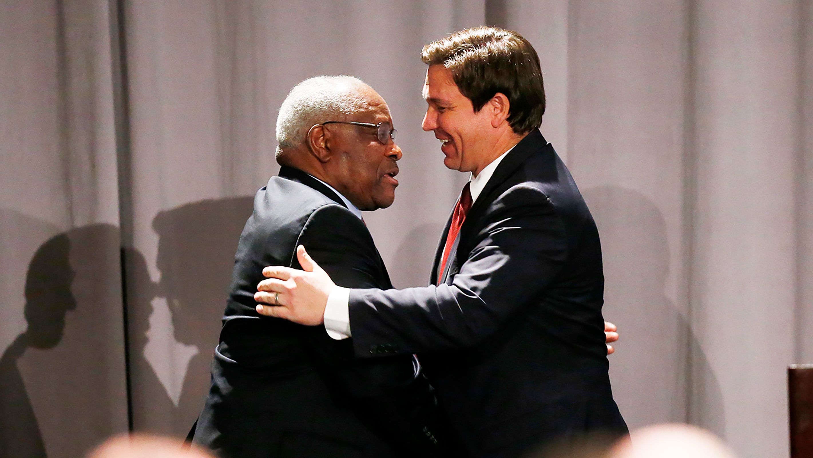 Clarence Thomas, left, and Ron DeSantis