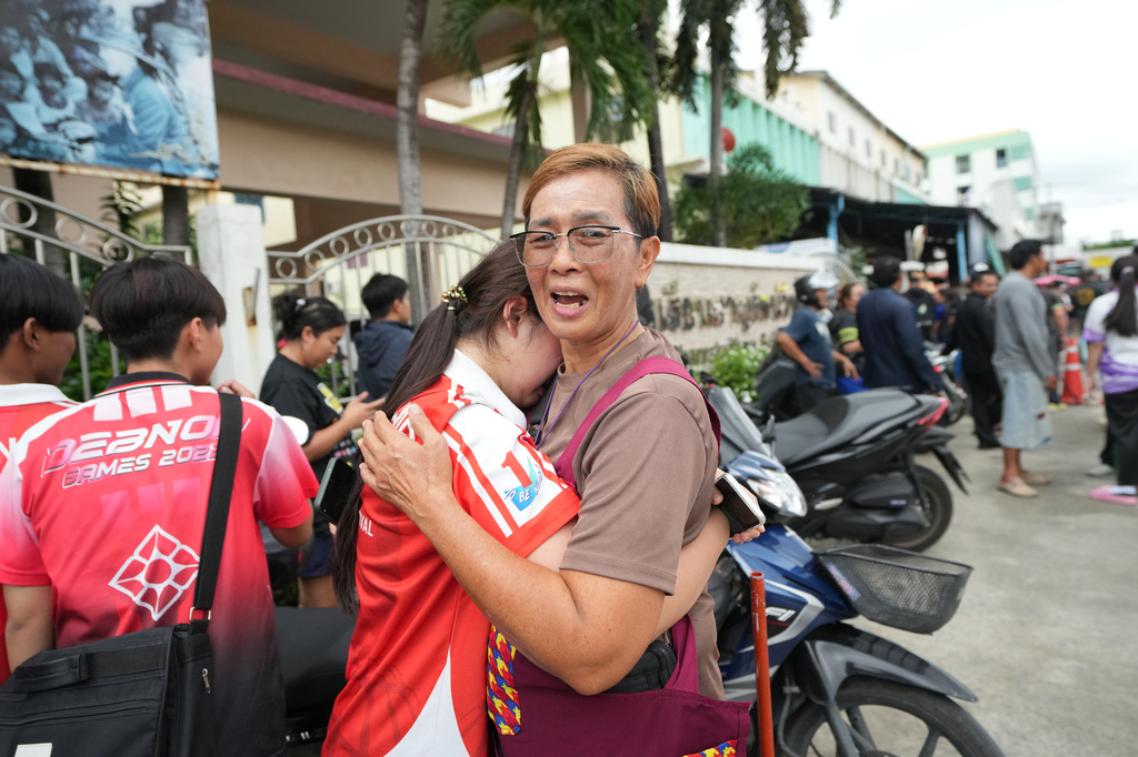 A schoolgirl cries outside her school where deaths and injuries were reported after a shooting in Thailand's Nonthaburi province, Friday, Aug. 7, 2026. 