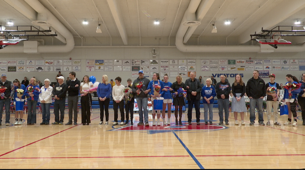 Family and friends of Ava Davey, Braeden Gunlock and Keni Wade lined up at senior night, Bigfork