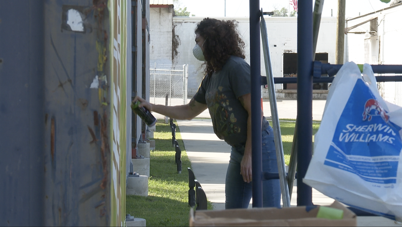 Artists begin painting large-scale shipping container murals at SoMo Walls