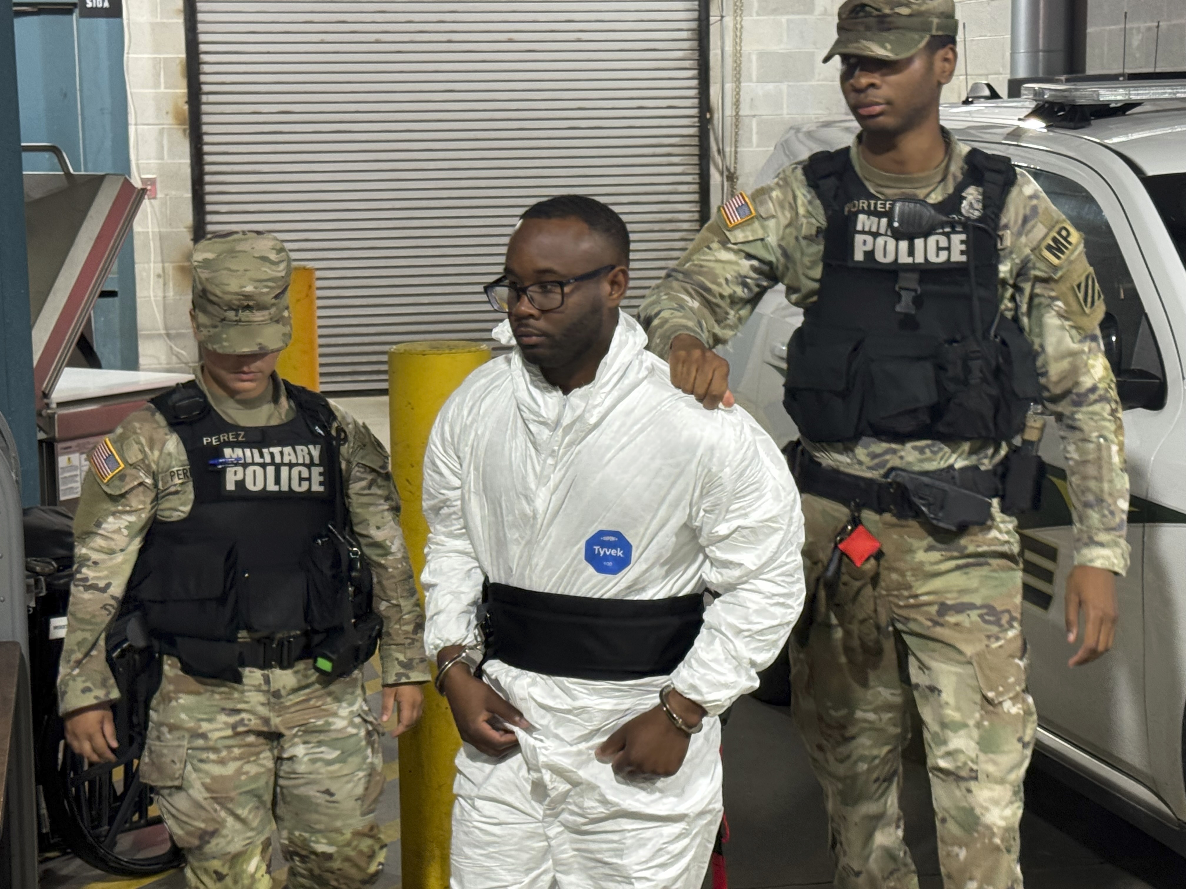 Sgt. Quornelius Radford, a suspect in the shooting of five soldiers at Fort Stewart, is escorted by military police into a booking room at the Liberty County Jail in Hinesville, Ga., Wednesday, Aug. 6, 2025. 