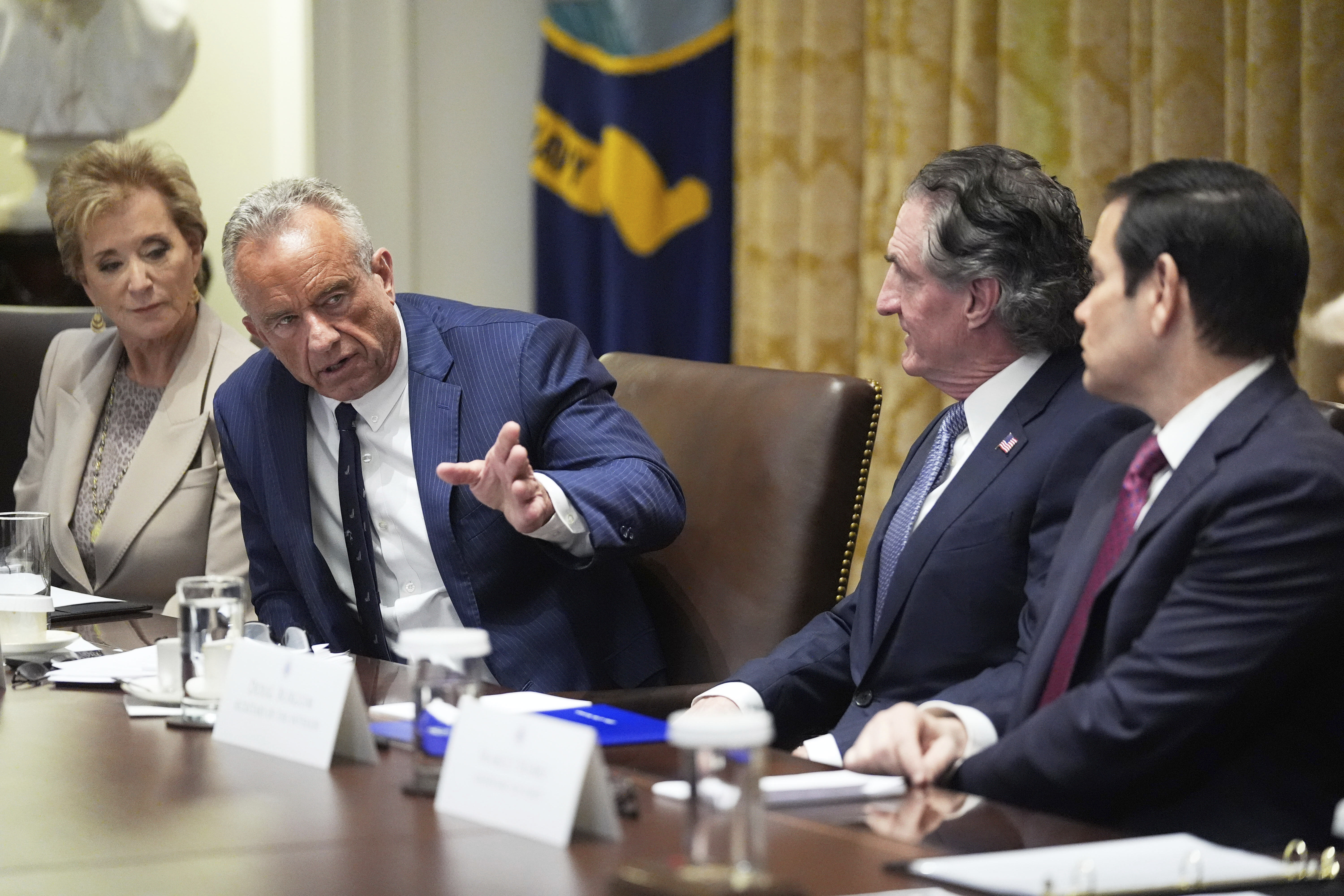 Secretary of Health and Human Services Robert F. Kennedy, Jr., speaks during a cabinet meeting with President Donald Trump, Tuesday, Aug. 26, 2025, at the White House in Washington, as from left, Secretary of Education Linda McMahon, Secretary of Interior Doug Burgum and Secretary of State Marco Rubio, look on. 