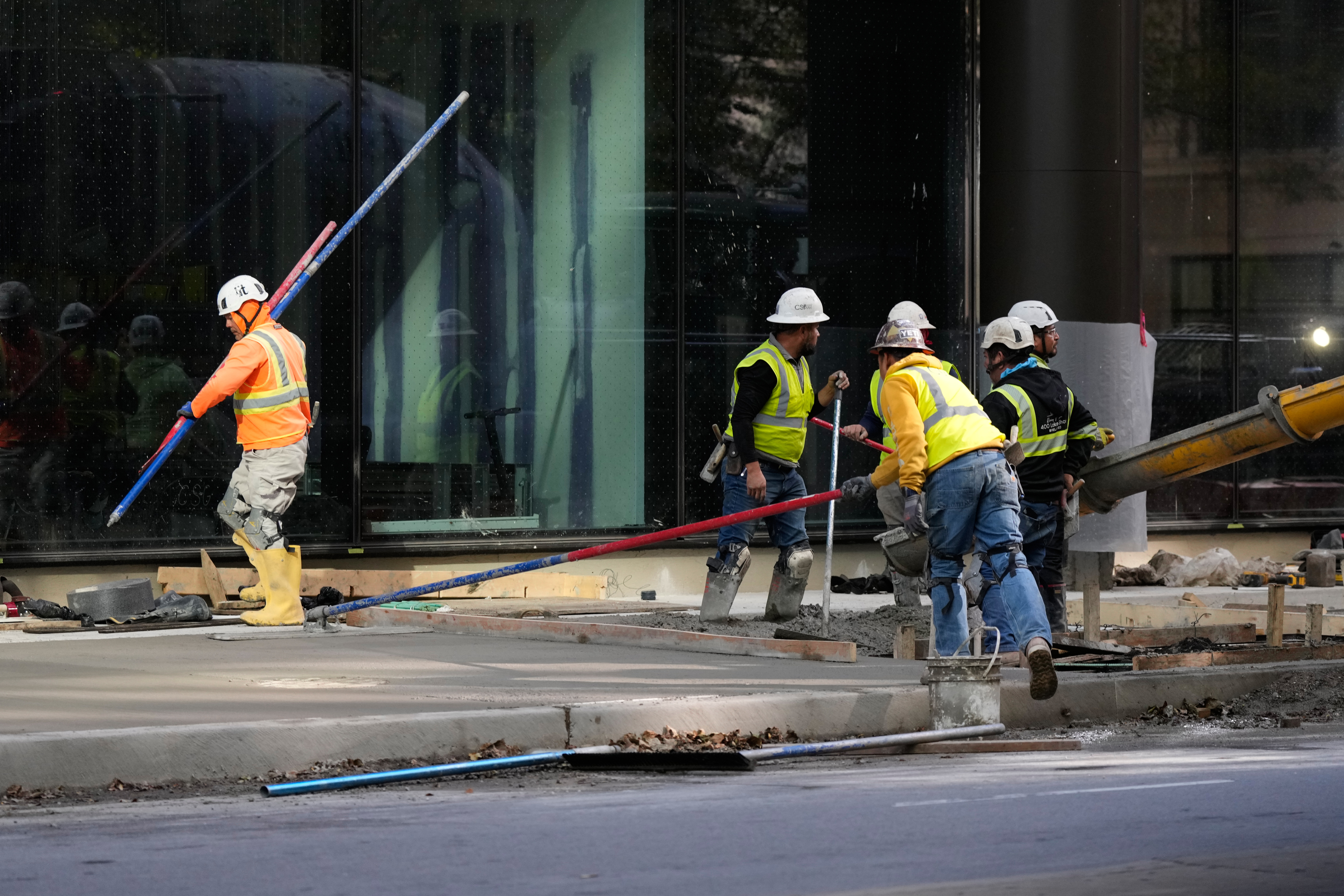 Construction workers work in Chicago, Tuesday, Oct. 20, 2026.