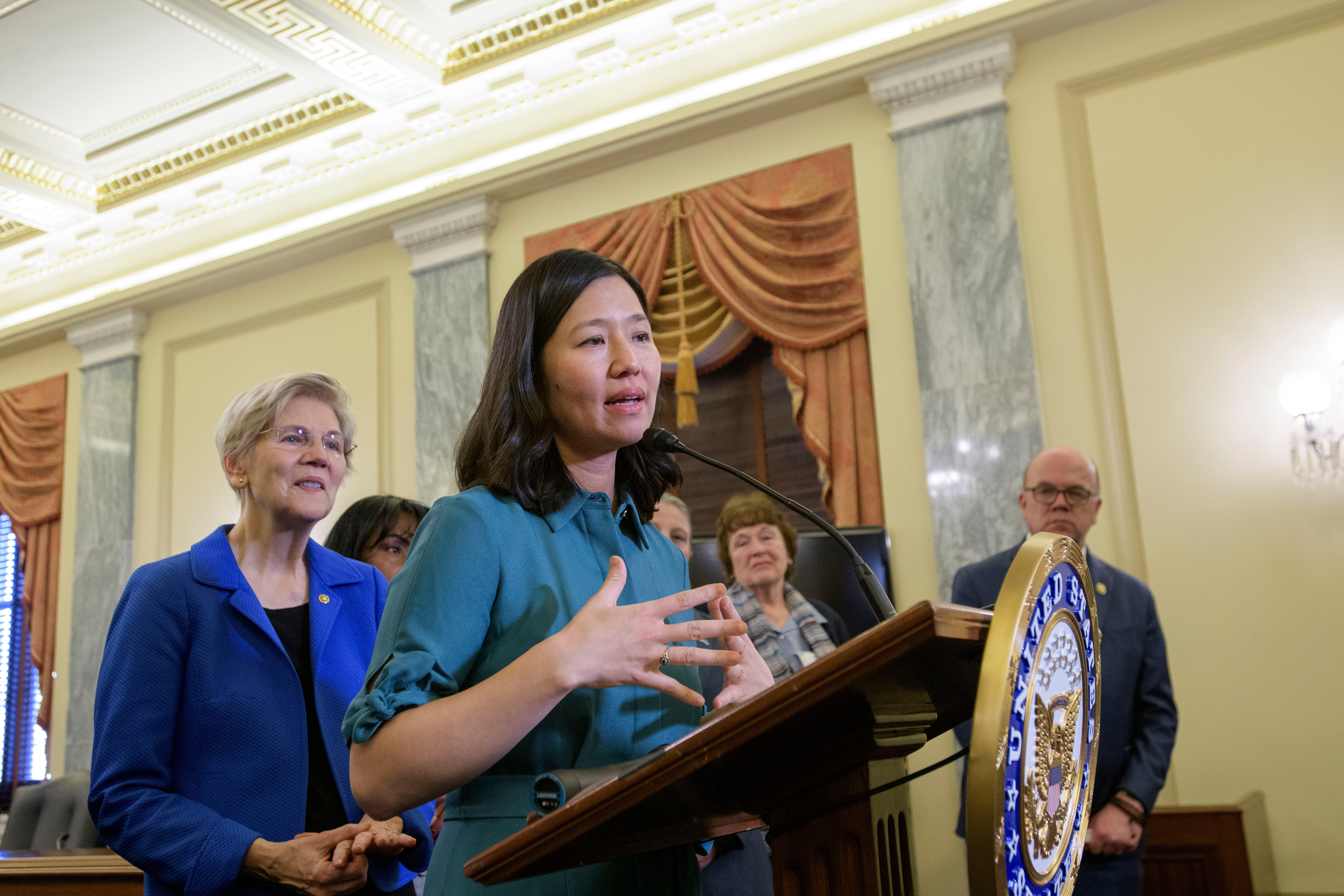 Boston Mayor Michelle Wu, right, is joined by Sen. Elizabeth Warren, D-Mass., left, as she speaks during a Massachusetts Congressional Delegation news conference regarding the impacts of the Trump administration's actions on communities across Massachusetts, March 4, 2025, in Washington. 