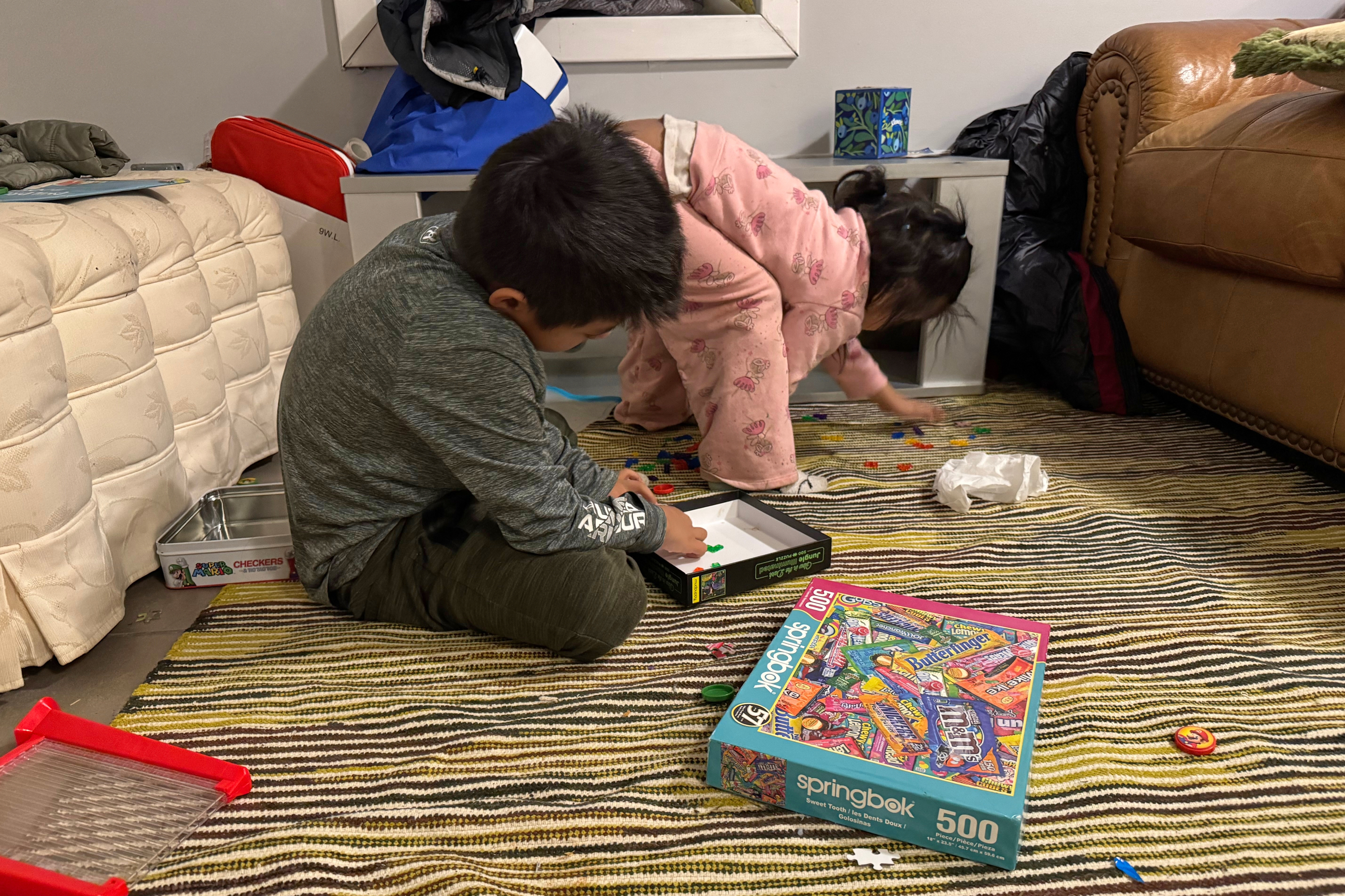 Two immigrant children play in a safe house in Minneapolis, Friday, Jan. 16, 2026, after volunteers relocated them from their home to protect them from federal agents. 