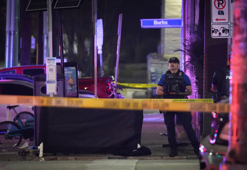 An Austin police officer guards the scene on West 6th Street at West Avenue after a shooting, Sunday March 1, 2026, in Austin, Texas.