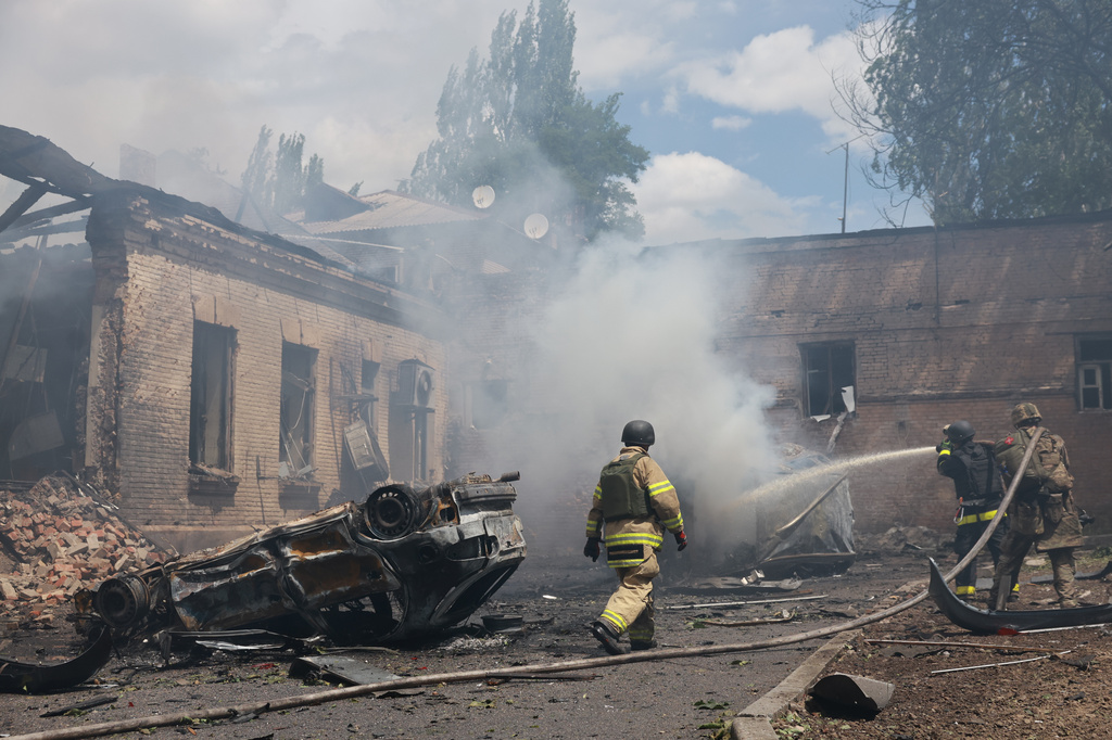 Rescue workers put out a fire at a building destroyed after a Russian strike on Zaporizhzhia, Ukraine, on Friday, June 26, 2026. 