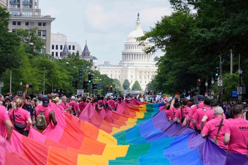 FILE - Participants carry a large pride flag during the World Pride parade with the U.S. Capitol in the background, June 7, 2025, in Washington.
