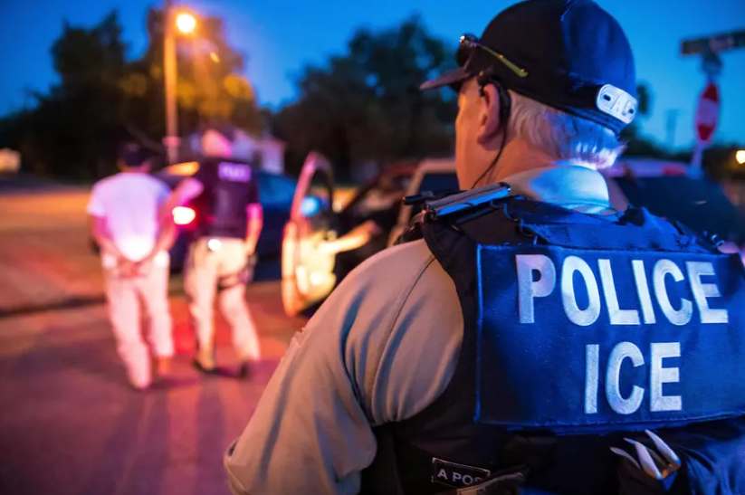 U.S. Immigration and Customs Enforcement officers carry out a raid in Sherman