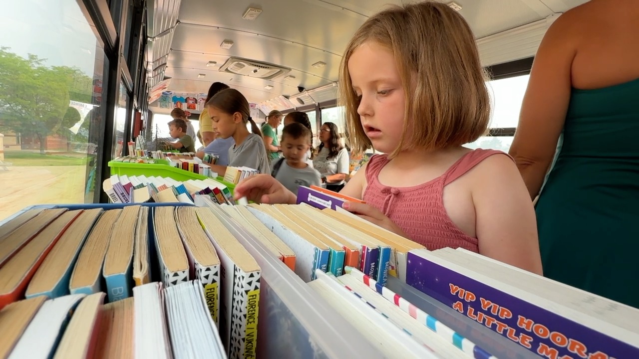 Girl picking out her books.jpg
