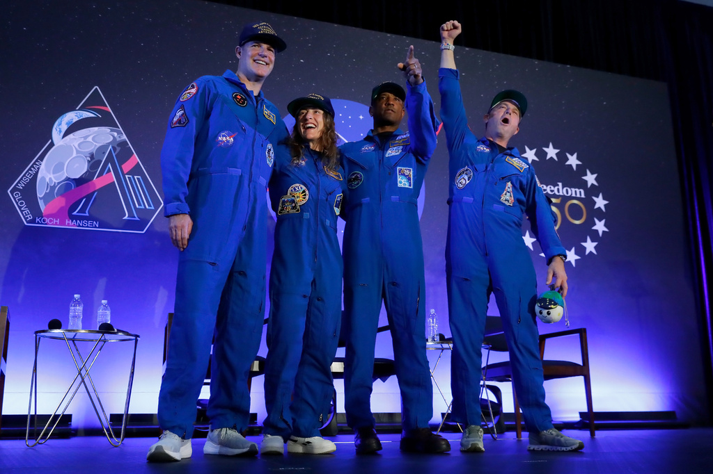 The Artemis II crew, from left, Jeremy Hansen, Christina Koch, Victor Glover and Reid Wiseman come to the center stage at the end of a crew return event Saturday, April 11, 2026, at Ellington Field in Houston.