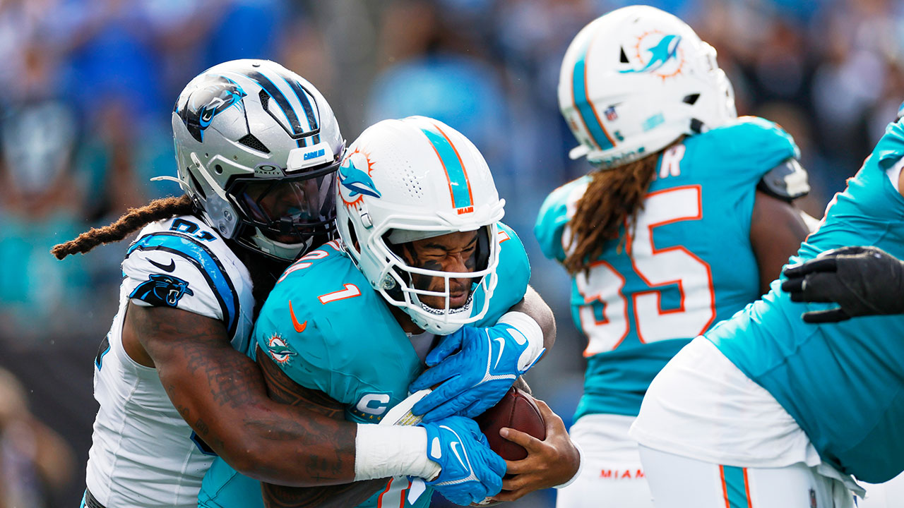Miami Dolphins quarterback Tua Tagovailoa is sacked by Carolina Panthers linebacker Patrick Jones II during the second half of an NFL football game, Sunday, Oct. 5, 2025, in Charlotte, N.C.